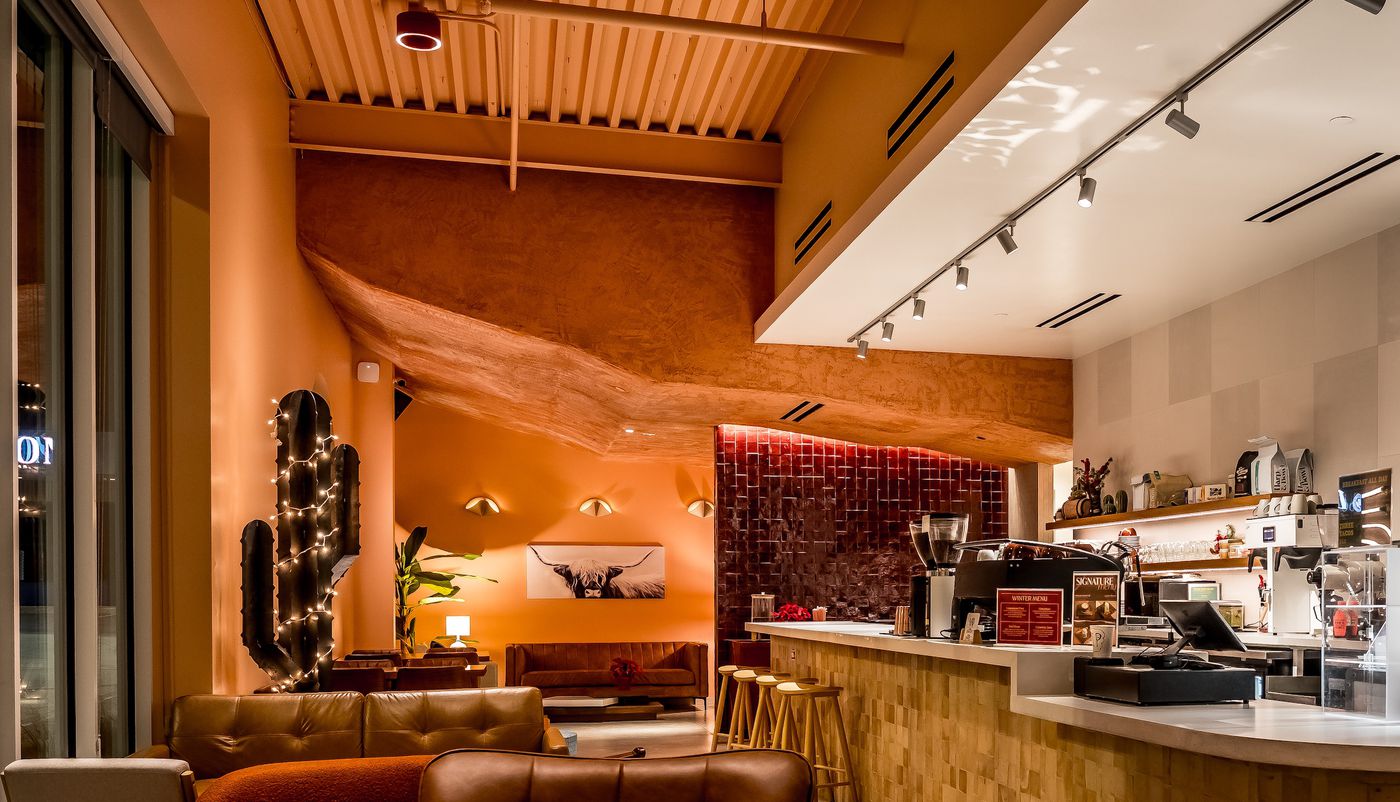 The hand-sculpted clay ledge that gives Cliff Coffee its name, running along the wall above the lounge